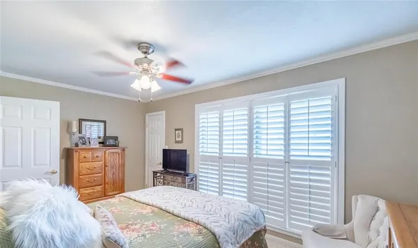 a bedroom with a large bed and a chandelier