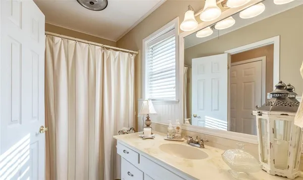 a bathroom with a granite countertop sink a toilet and a mirror