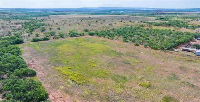 an aerial view of lake with residential houses with outdoor space