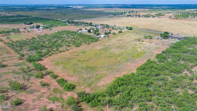 an aerial view of ocean with residential house with beach and outdoor space