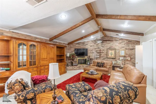 a living room with furniture fireplace and flat screen tv