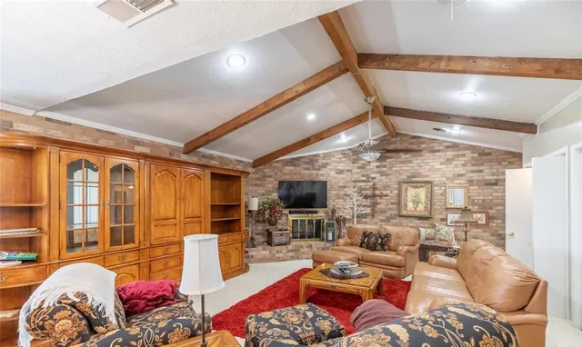 a living room with furniture a flat screen tv and a floor to ceiling window