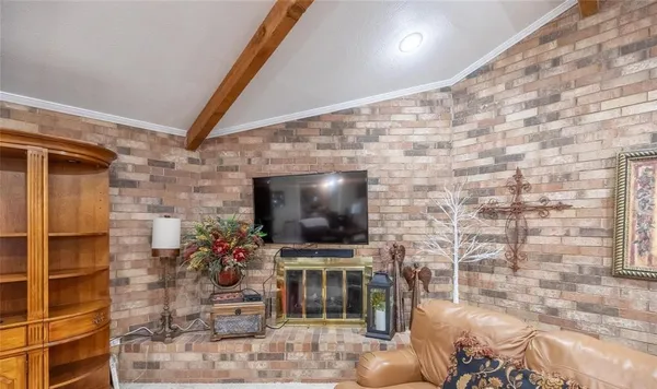 a living room with a flat screen tv and a fireplace