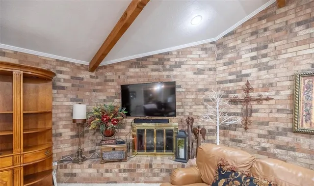 a living room with a flat screen tv and a fireplace