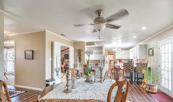 a view of a livingroom with furniture wooden floor and a ceiling fan