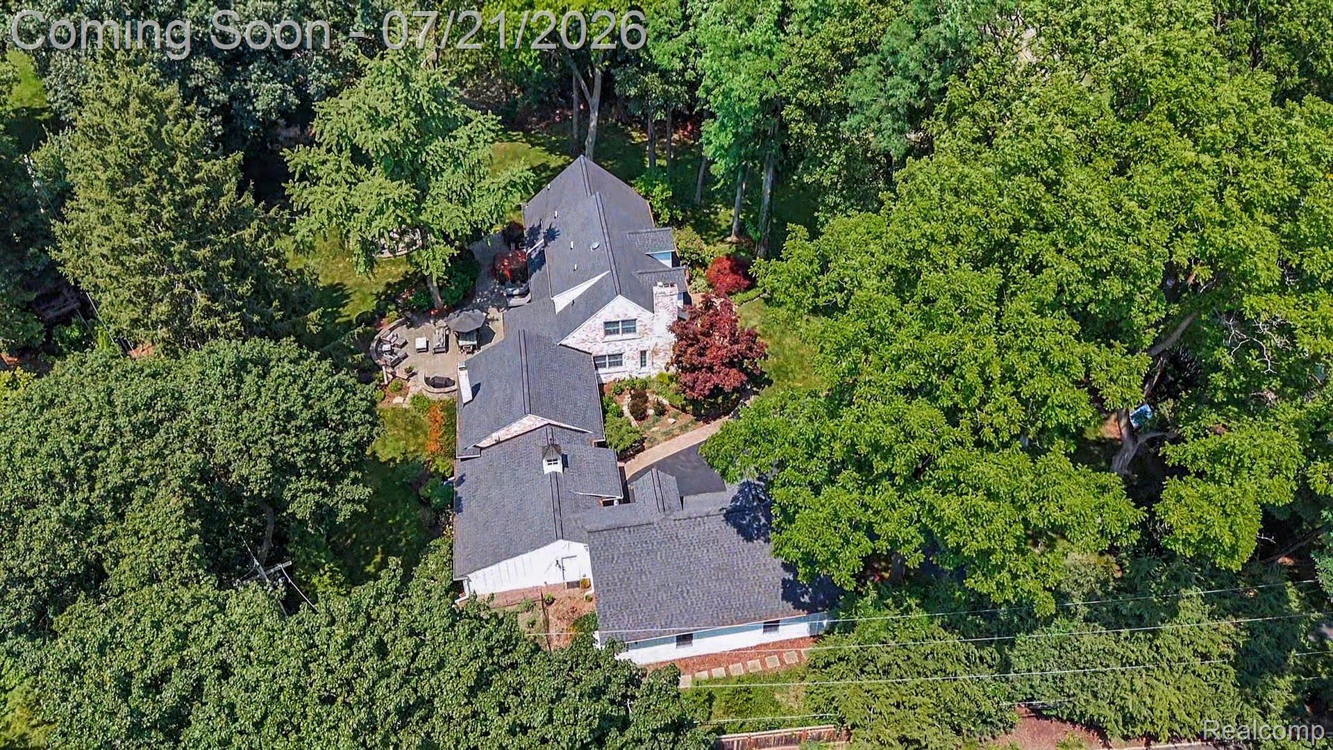 3780 Squirrel Road Bloomfield Hills, MI 48304 - Photo 52 of 59 Expansive property featuring a multi-level roofline, extensive mature tree coverage, a stone patio, and established landscaping