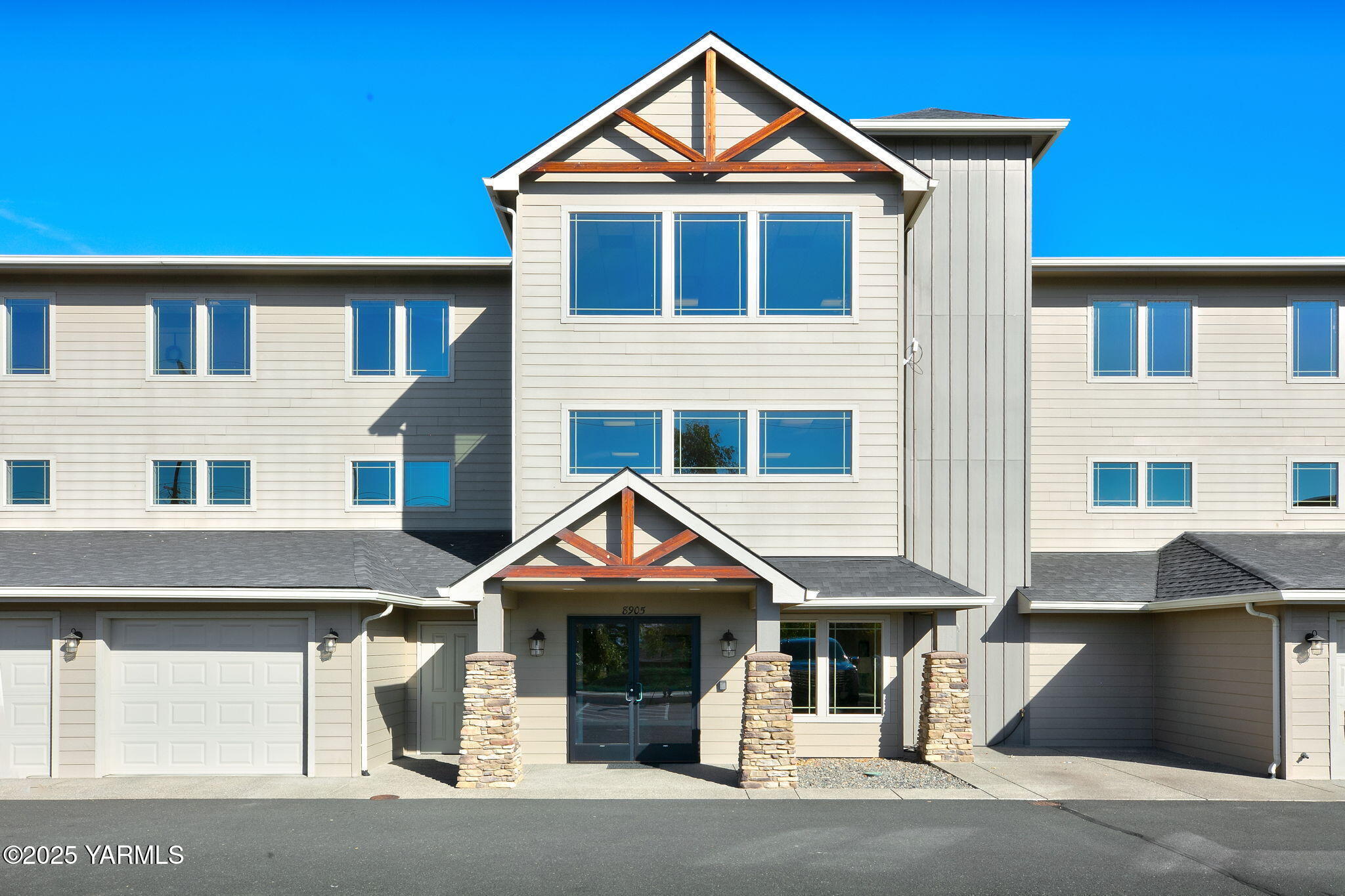 8905 Occidental Road, Unit 301A Yakima, WA 98903 - Photo 2 of 24 a front view of a house with a yard