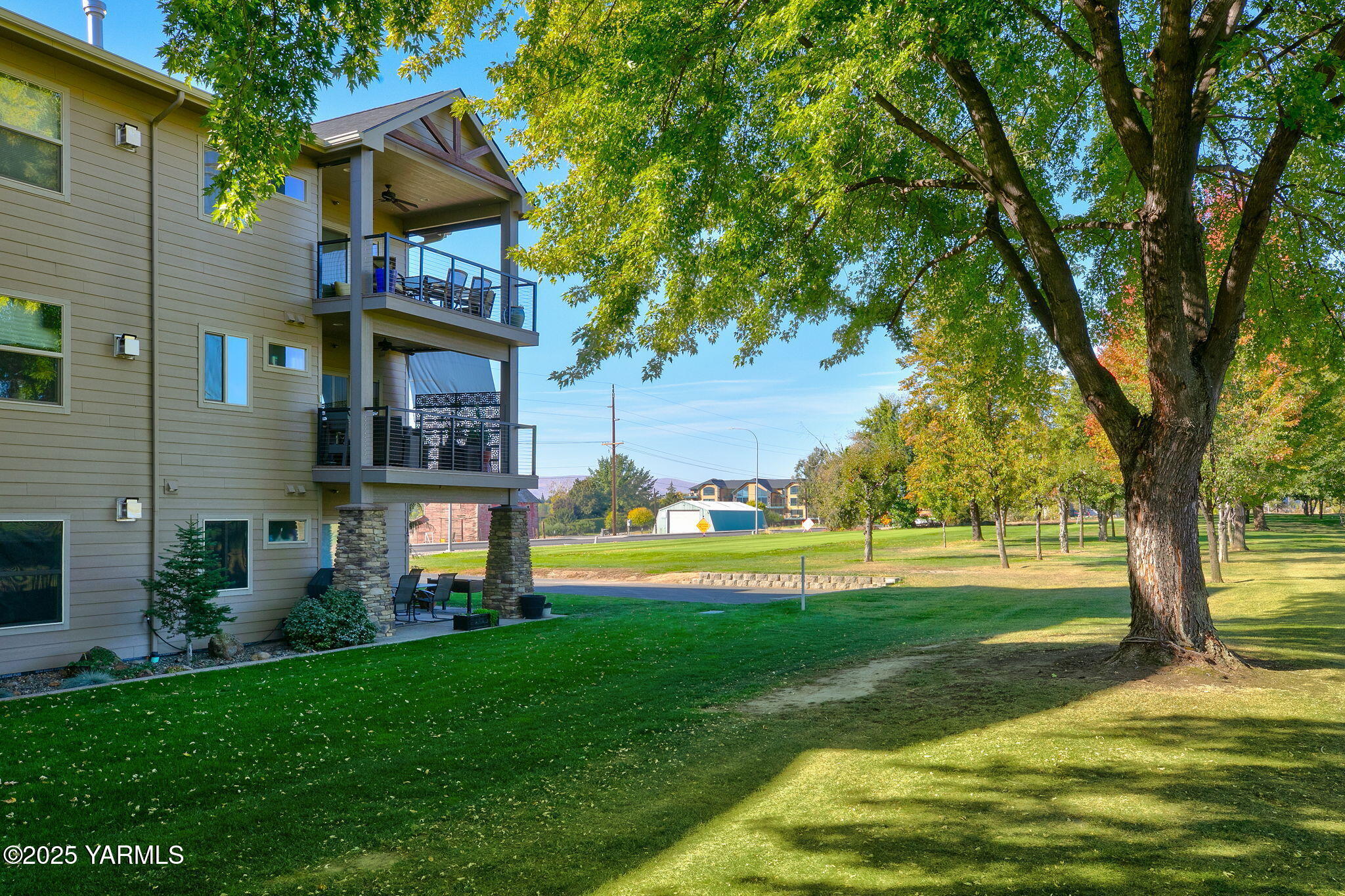 8905 Occidental Road, Unit 301A Yakima, WA 98903 - Photo 4 of 24 a view of a house with swimming pool and a big yard
