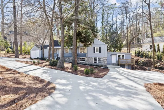 a view of a house with snow on the road