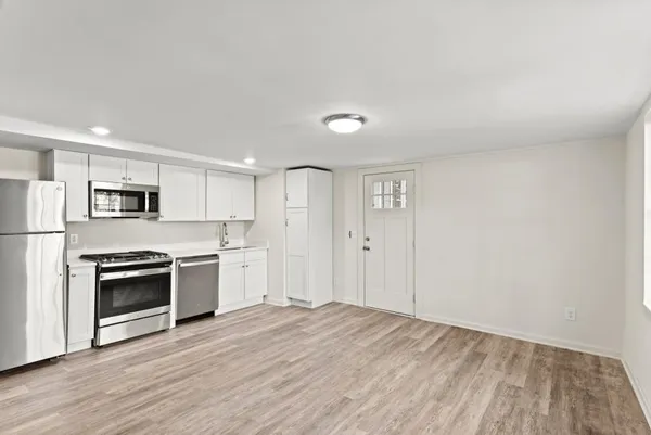 a view of a kitchen with a stove cabinets and wooden floor
