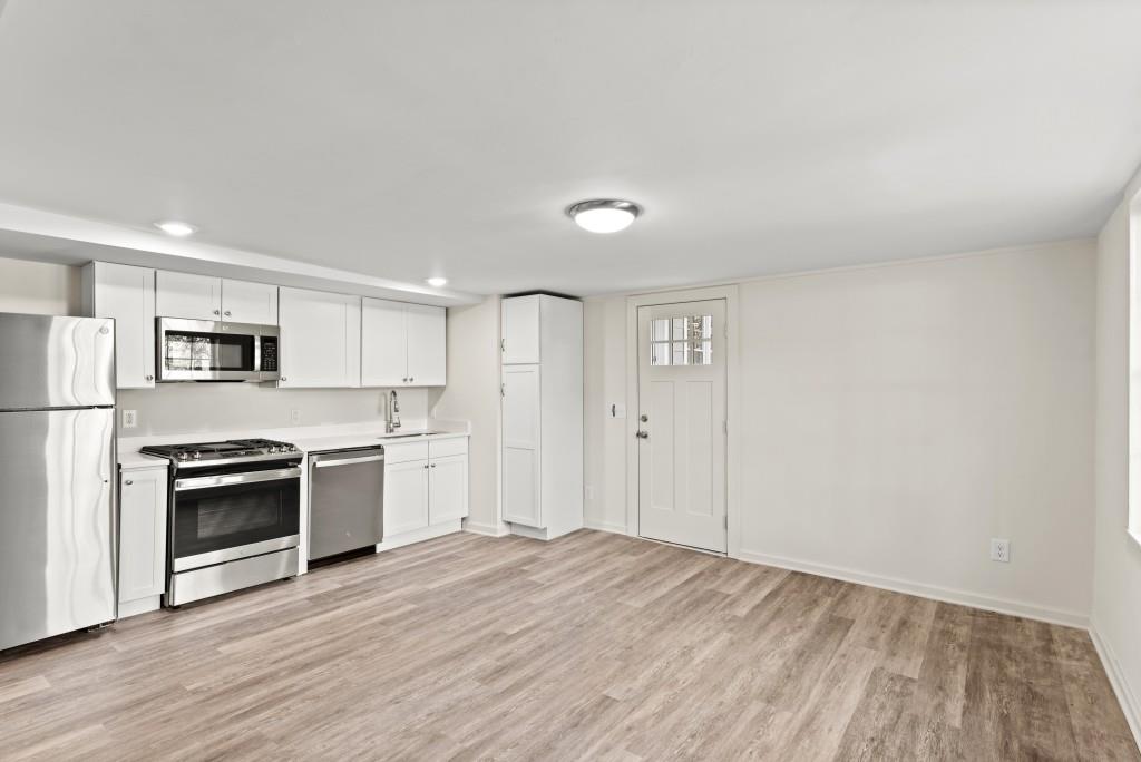 3310 East Roxboro Road Northeast Atlanta, GA 30324 - Photo 23 of 47 a view of a kitchen with a stove cabinets and wooden floor