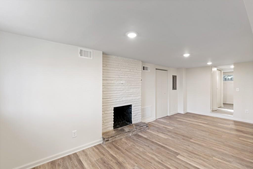 3310 East Roxboro Road Northeast Atlanta, GA 30324 - Photo 25 of 47 a view of empty room with wooden floor and fireplace