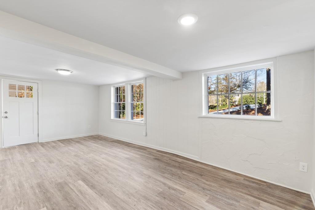 3310 East Roxboro Road Northeast Atlanta, GA 30324 - Photo 34 of 47 a view of an empty room with a window and wooden floor