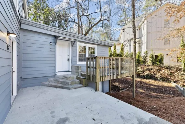 a view of a house with a wooden deck