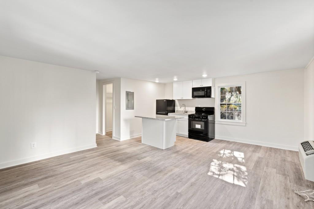 3310 East Roxboro Road Northeast Atlanta, GA 30324 - Photo 38 of 47 a kitchen with stainless steel appliances wooden floor and view living room