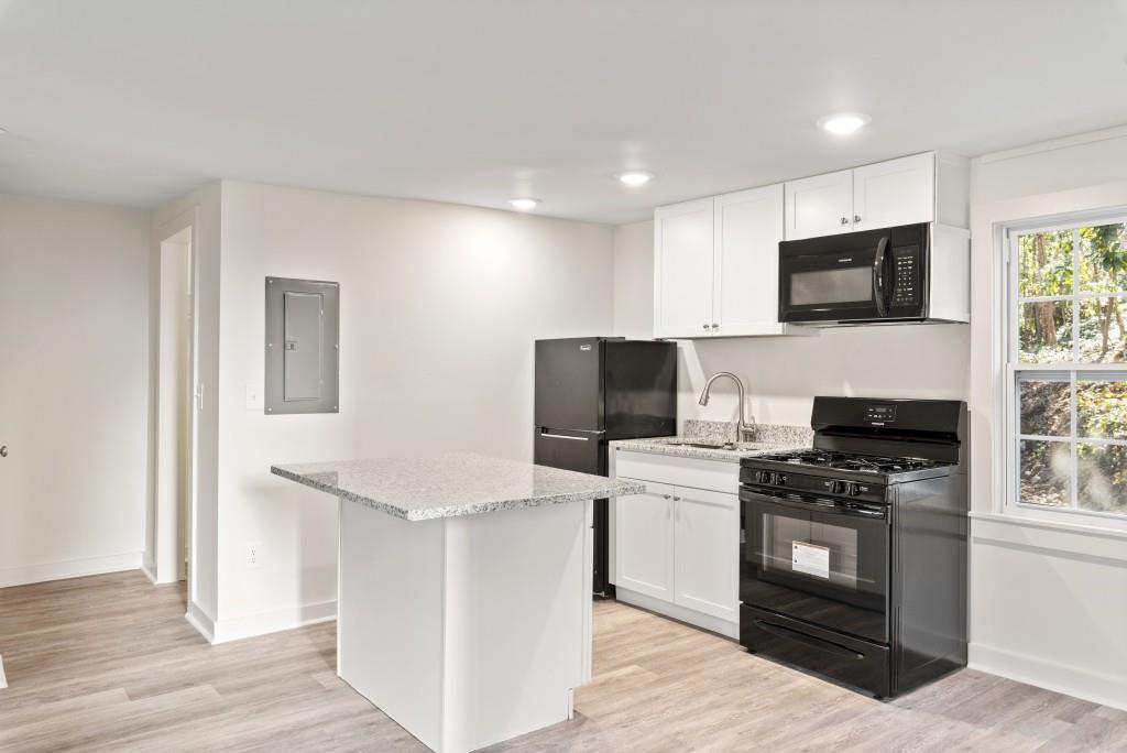 3310 East Roxboro Road Northeast Atlanta, GA 30324 - Photo 39 of 47 a kitchen with a stove and a microwave
