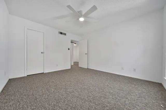 a bathroom with a granite countertop sink a toilet and a mirror