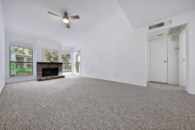 a view of empty room with fireplace