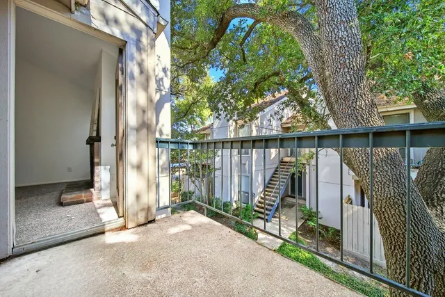a view of balcony with wooden floor and fence