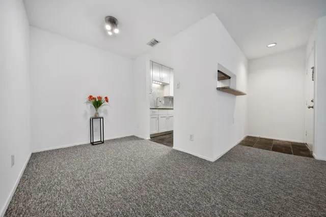 an empty room with windows and entrance