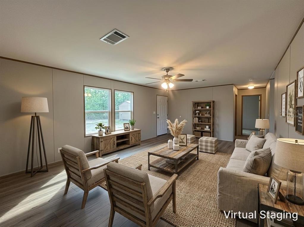 114 Nutmeg Trail Interlachen, FL 32148 - Photo 5 of 33 a living room with furniture a large window and a table