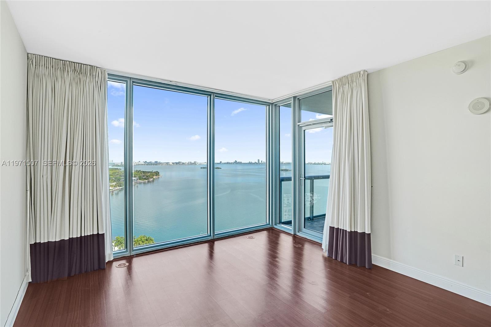 601 Northeast 36th Street, Unit 1908 Miami, FL 33137 - Photo 11 of 57 wooden floor in an empty room with a window