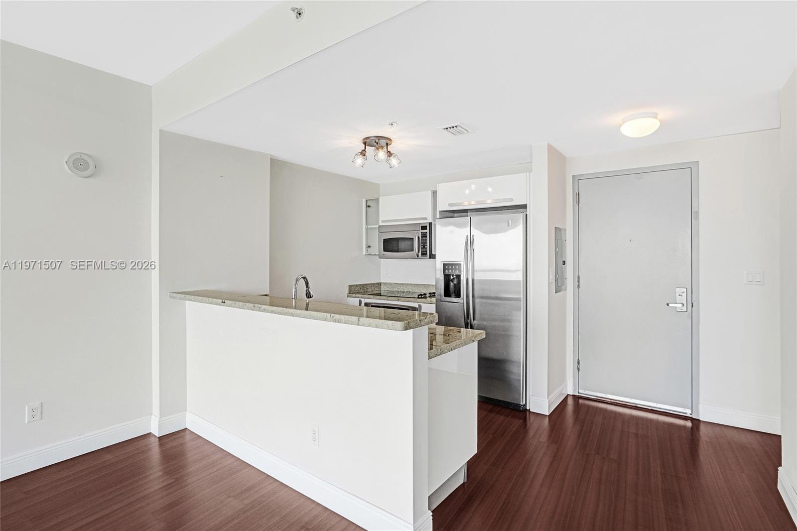 601 Northeast 36th Street, Unit 1908 Miami, FL 33137 - Photo 17 of 57 a kitchen with stainless steel appliances a refrigerator and a stove top oven
