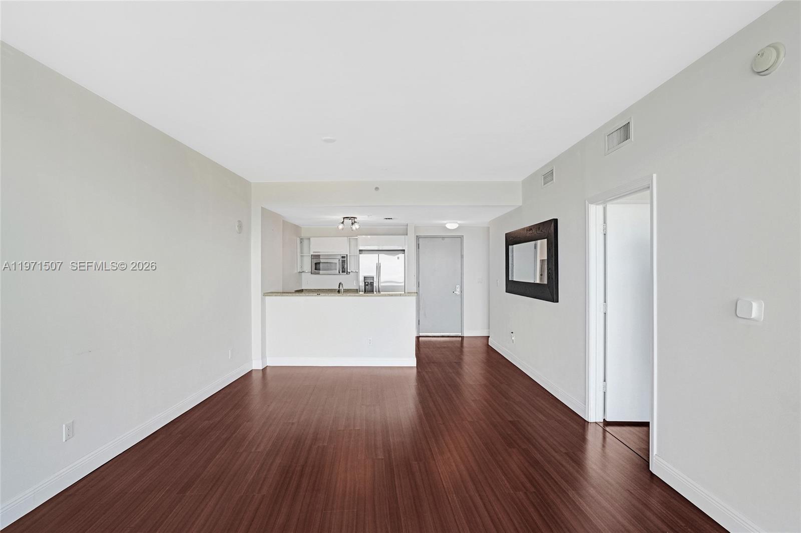 601 Northeast 36th Street, Unit 1908 Miami, FL 33137 - Photo 31 of 57 a view of a big room with wooden floor and windows