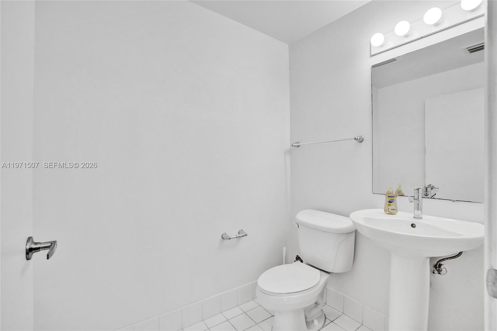 601 Northeast 36th Street, Unit 1908 Miami, FL 33137 - Photo 4 of 57 a bathroom with a sink toilet and mirror