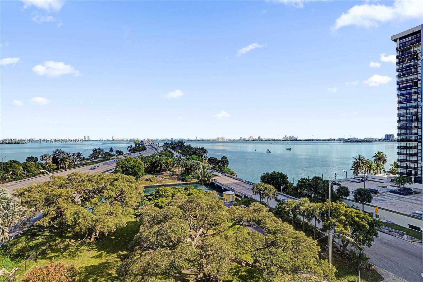 601 Northeast 36th Street, Unit 1908 Miami, FL 33137 - Photo 48 of 57 a view of a lake with table and chairs