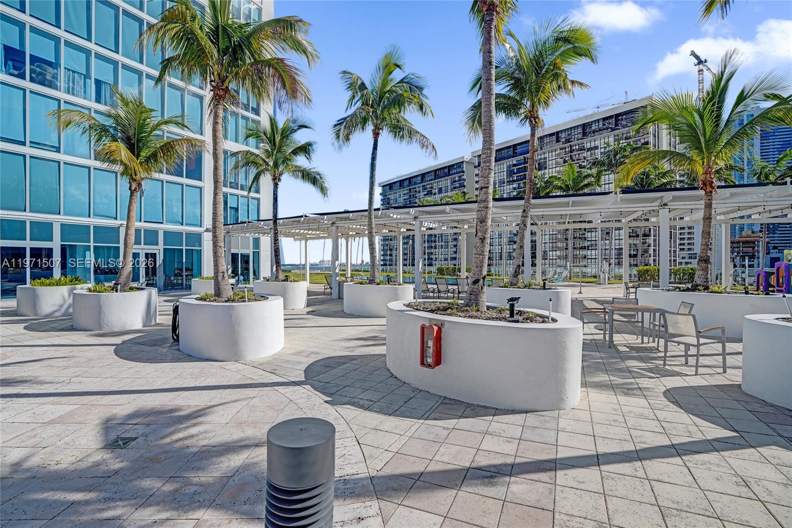 601 Northeast 36th Street, Unit 1908 Miami, FL 33137 - Photo 57 of 57 a view of a patio with dining table and chairs potted plants