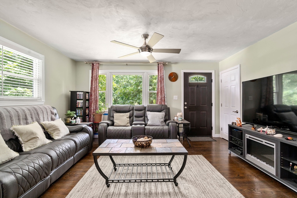5 Flint Road Tyngsboro, MA 01879 - Photo 5 of 31 a living room with furniture a flat screen tv and a large window