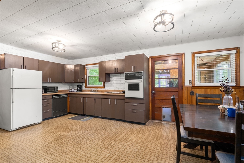 5 Flint Road Tyngsboro, MA 01879 - Photo 10 of 31 a kitchen with a refrigerator and a stove top oven