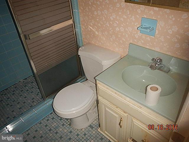 12907 Holdridge Road Silver Spring, MD 20906 - Photo 11 of 14 a bathroom with a sink and a toilet