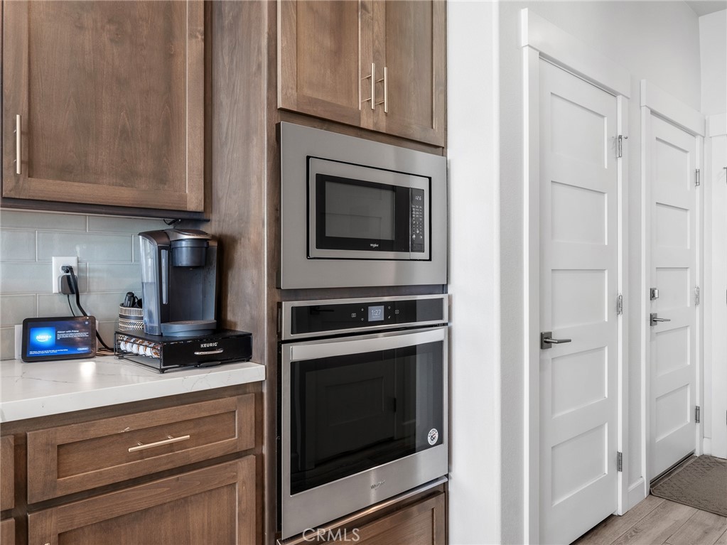 22427 Huasna Road Apple Valley, CA 92307 - Photo 14 of 39 a kitchen with granite countertop white cabinets and stainless steel appliances