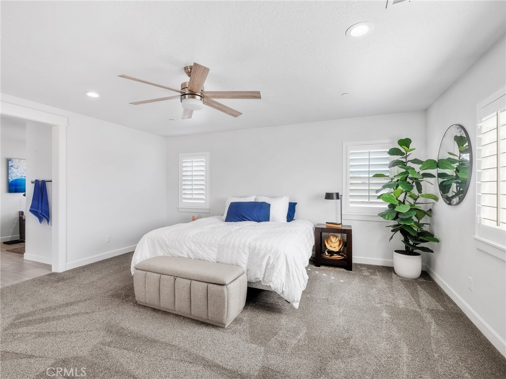 22427 Huasna Road Apple Valley, CA 92307 - Photo 16 of 39 a bedroom with a bed and ceiling fan