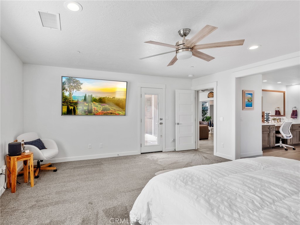22427 Huasna Road Apple Valley, CA 92307 - Photo 18 of 39 a bedroom with a bed and a chandelier