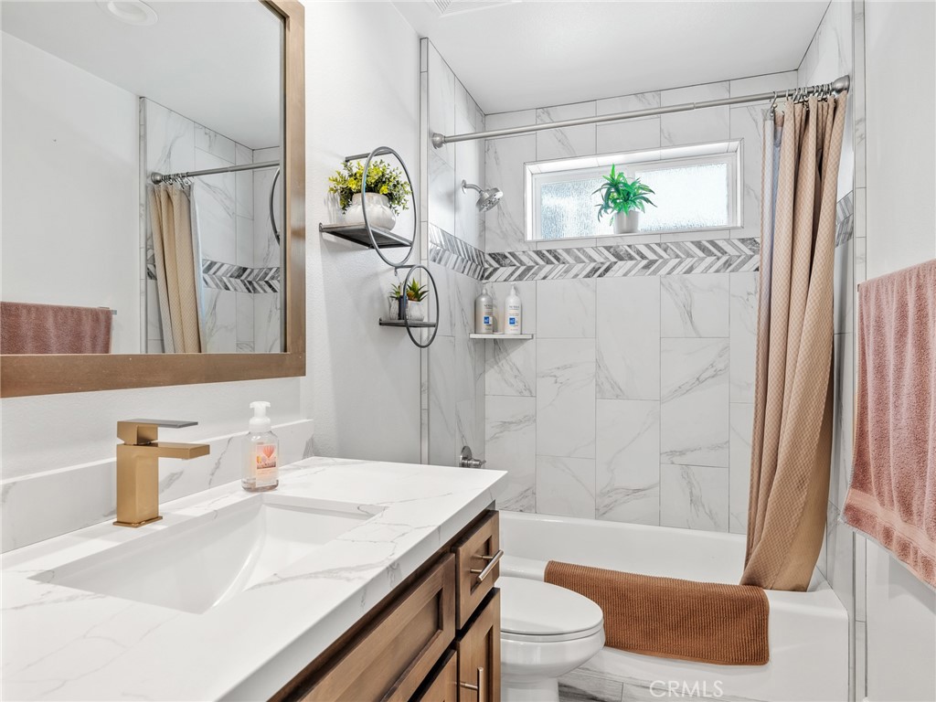 22427 Huasna Road Apple Valley, CA 92307 - Photo 28 of 39 a bathroom with a sink a toilet and shower