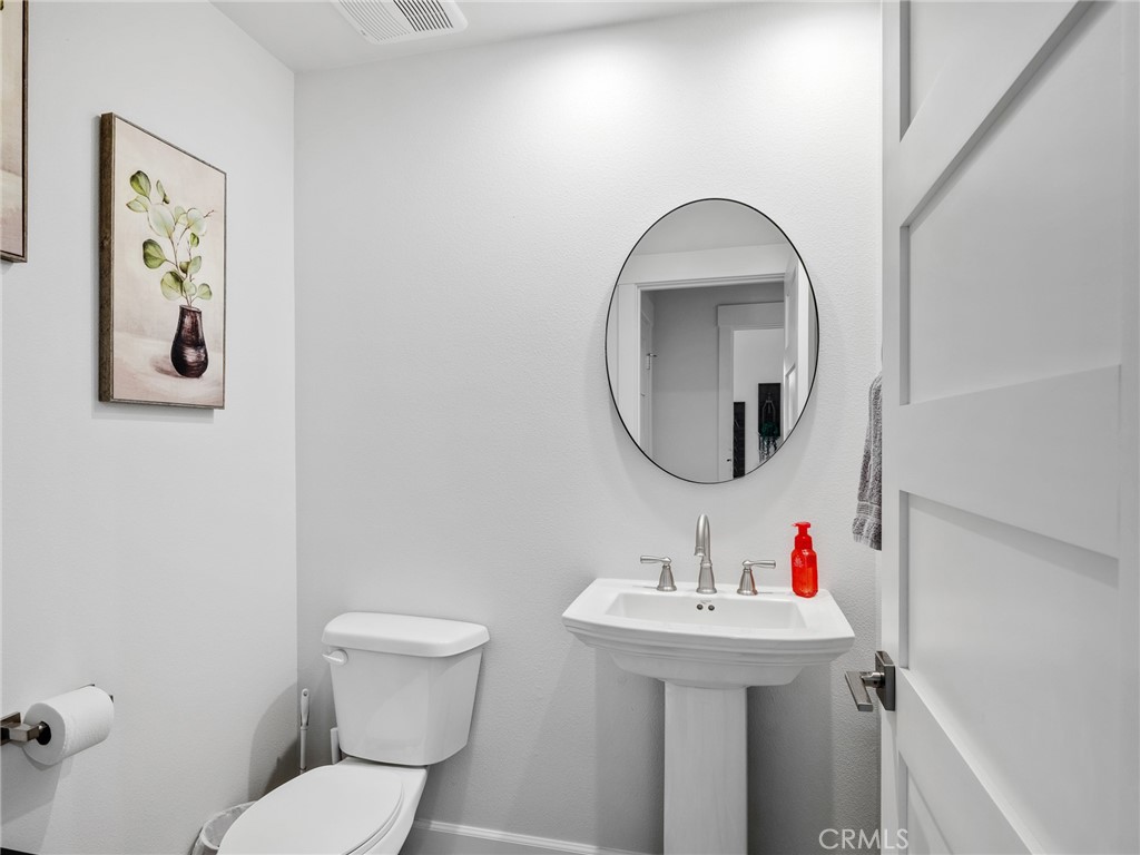 22427 Huasna Road Apple Valley, CA 92307 - Photo 29 of 39 a bathroom with a toilet sink and mirror