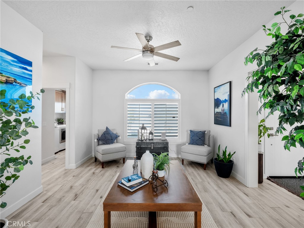 22427 Huasna Road Apple Valley, CA 92307 - Photo 5 of 39 a living room with furniture chandelier and a potted plant