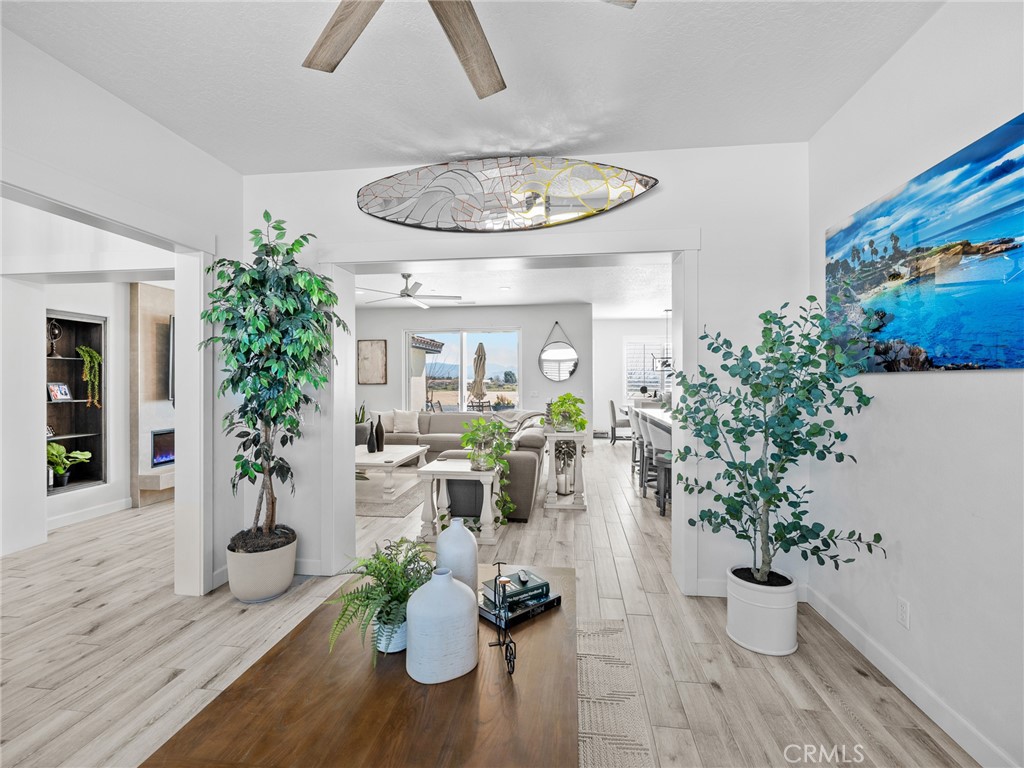 22427 Huasna Road Apple Valley, CA 92307 - Photo 6 of 39 a dining room with furniture a potted plant and wooden floor