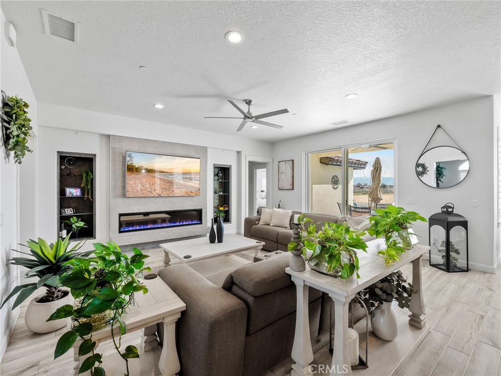 22427 Huasna Road Apple Valley, CA 92307 - Photo 7 of 39 a living room with furniture and a flat screen tv