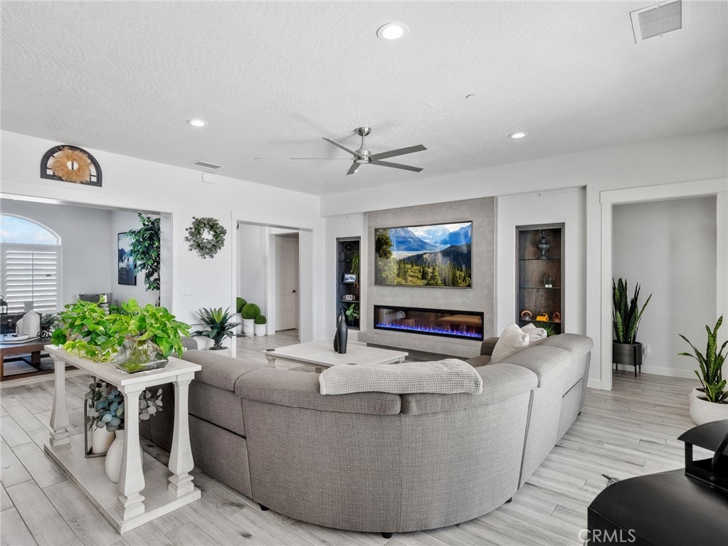 22427 Huasna Road Apple Valley, CA 92307 - Photo 8 of 39 a living room with furniture and a flat screen tv