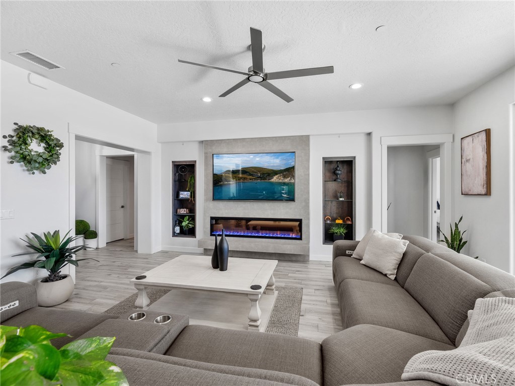 22427 Huasna Road Apple Valley, CA 92307 - Photo 9 of 39 a living room with furniture and a flat screen tv