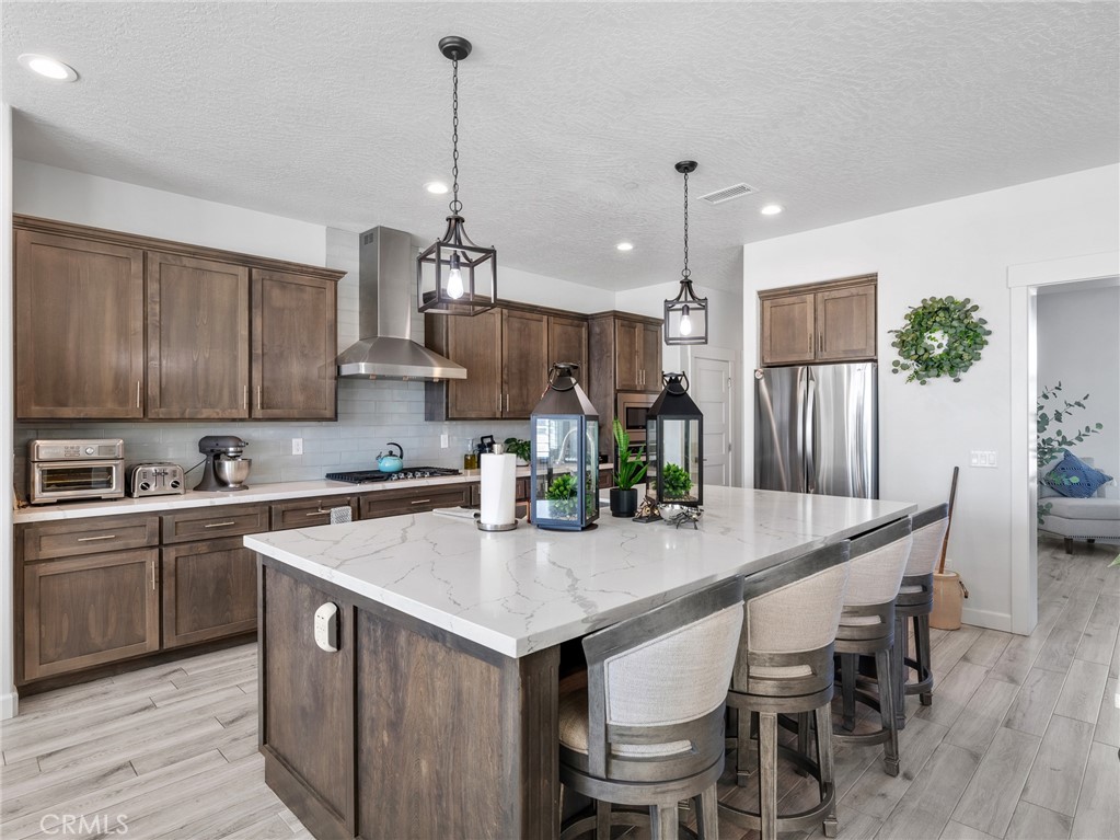 22427 Huasna Road Apple Valley, CA 92307 - Photo 10 of 39 a kitchen with granite countertop white cabinets and stainless steel appliances