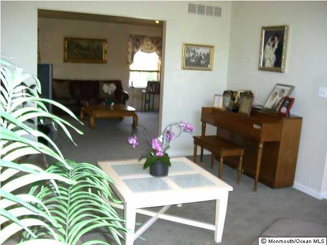 45 Georgetown Road Eatontown, NJ 07724 - Photo 2 of 3 a dining room with furniture and a lamp