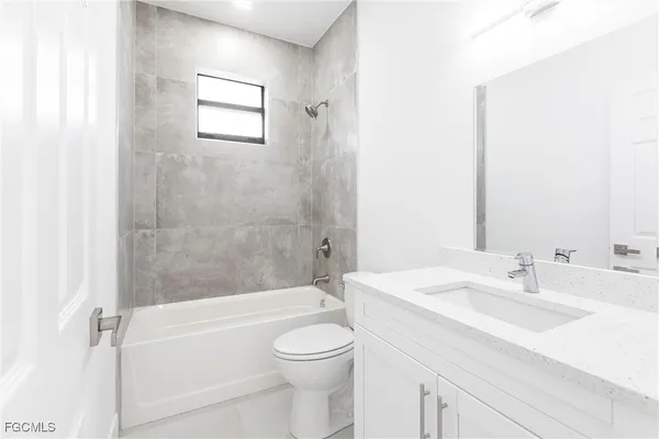 a bathroom with a sink a toilet and a bathtub