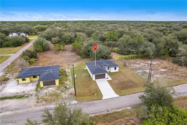 an aerial view of a house with a yard