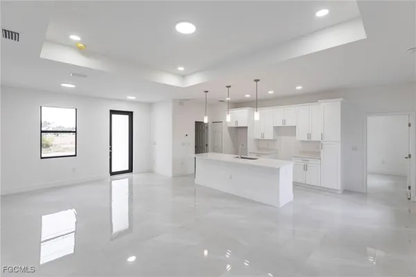 a large room with a large window and stainless steel appliances