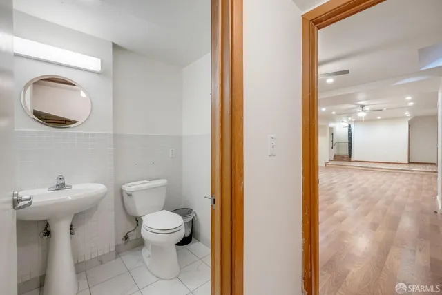 a bathroom with a toilet a sink and a mirror